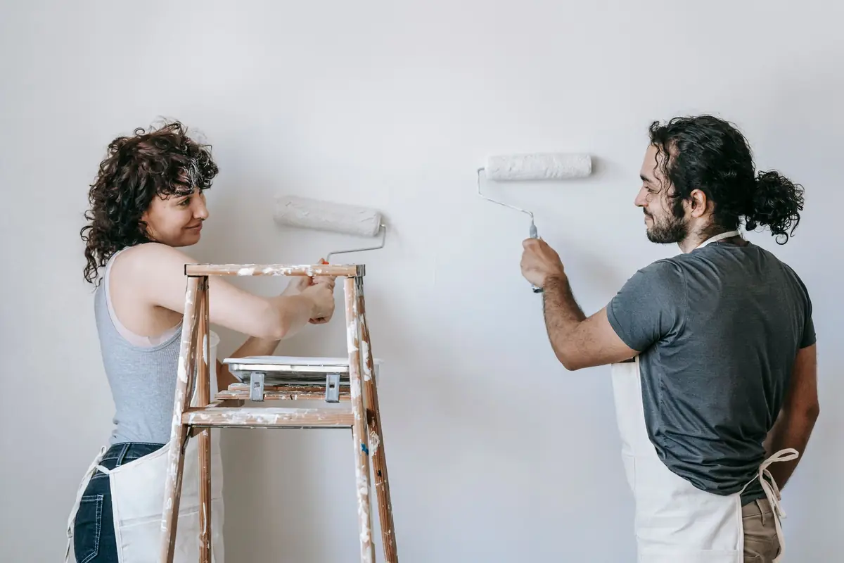 People painting a wall together — painting help in Baton Rouge